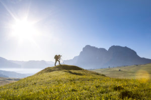 A photographer in action on field, Alpe di Siusi (Seiser Alm), Castelrotto (Kastelruth), Dolomites, South Tyrol, Italy A photographer in action on field, Alpe di Siusi (Seiser Alm), Castelrotto (Kastelruth), Dolomites, South Tyrol, Italy